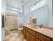 Well-maintained bathroom with tiled shower/tub, decorative lighting, and a large mirror at 30017 Johnston Rd, Dade City, FL 33523