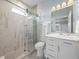 Bathroom with large shower, marble floors, marble walls, and decorative lighting at 30017 Johnston Rd, Dade City, FL 33523