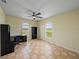 Spacious bedroom with ceiling fan, tile floors, and arched windows with natural light at 30017 Johnston Rd, Dade City, FL 33523