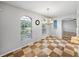 Bright dining room boasts checkered tile, large windows, pendant lighting and an arched doorway at 30017 Johnston Rd, Dade City, FL 33523