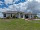 Well-maintained home featuring elegant arched windows and beautifully landscaped front yard at 30017 Johnston Rd, Dade City, FL 33523