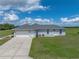 Charming home featuring a two-car garage, large driveway, and a well-maintained lawn at 30017 Johnston Rd, Dade City, FL 33523