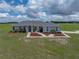 Charming home featuring a beautifully landscaped front yard, well-maintained lawn, and inviting curb appeal at 30017 Johnston Rd, Dade City, FL 33523