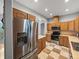 Modern kitchen with stainless steel appliances, tile floors, and tan countertops at 30017 Johnston Rd, Dade City, FL 33523