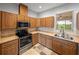 Kitchen showcasing stainless steel oven, microwave and natural wood cabinets at 30017 Johnston Rd, Dade City, FL 33523