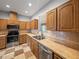 Modern kitchen showcasing stainless steel appliances, wood cabinets, checkered tile floors and great lighting at 30017 Johnston Rd, Dade City, FL 33523
