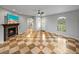 Living room features a fireplace, ceiling fan, arched doorways, checkered tile floors and a front entrance at 30017 Johnston Rd, Dade City, FL 33523