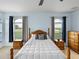 Spacious bedroom with blue walls, ceiling fan and natural light from large windows at 30017 Johnston Rd, Dade City, FL 33523