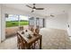 Bright patio with tile flooring, a ceiling fan, large sliding doors, and scenic backyard views at 30017 Johnston Rd, Dade City, FL 33523