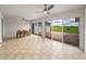 Bright sunroom with ceiling fans, tile floor, dining table, and sliding glass doors to the brick patio and backyard at 30017 Johnston Rd, Dade City, FL 33523