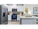 Contemporary kitchen featuring stainless steel appliances, white cabinets, and stylish countertops at 31246 Midnight Sun Way, Wesley Chapel, FL 33545