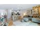 Open-concept living space with a kitchen island, comfortable seating, and stylish artwork at 31246 Midnight Sun Way, Wesley Chapel, FL 33545