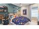 themed bedroom with colorful bedding, playful decor, and built-in desk at 34053 Anchor Light Ln, Wesley Chapel, FL 33543
