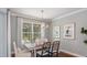 Bright dining room with elegant lighting, stylish furniture, and a view of the outdoor space at 34053 Anchor Light Ln, Wesley Chapel, FL 33543
