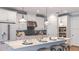 Modern kitchen featuring white cabinets, stainless steel appliances, and a large island with seating at 34053 Anchor Light Ln, Wesley Chapel, FL 33543