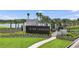 Welcoming community sign with lush landscaping and tranquil lake backdrop at 34053 Anchor Light Ln, Wesley Chapel, FL 33543