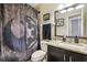 Neutral bathroom with granite countertop, a well lit mirror, and unique shower curtain at 3530 Brook Crossing Dr, Brandon, FL 33511
