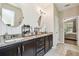 Bathroom featuring dual sinks with granite countertops and modern lighting fixtures at 3530 Brook Crossing Dr, Brandon, FL 33511