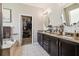 Spa-like bathroom with a soaking tub, a walk-in closet, and dual sinks with granite countertops at 3530 Brook Crossing Dr, Brandon, FL 33511