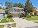 Charming two-story home featuring a well-manicured lawn, mature trees, and an attached two-car garage at 3530 Brook Crossing Dr, Brandon, FL 33511