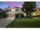 Charming two-story home featuring a well-manicured lawn, mature trees, and an attached two-car garage at 3530 Brook Crossing Dr, Brandon, FL 33511