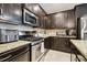 Well-equipped kitchen with granite countertops, stainless steel appliances, and tile backsplash at 3530 Brook Crossing Dr, Brandon, FL 33511