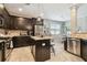 Modern kitchen with granite countertops, stainless steel appliances, and dark wood cabinets at 3530 Brook Crossing Dr, Brandon, FL 33511
