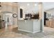 Open-concept kitchen features granite countertops, dark wood cabinets, and a convenient breakfast bar at 3530 Brook Crossing Dr, Brandon, FL 33511