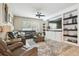 Comfortable living room with a large sectional sofa, built-in shelving, and a ceiling fan at 3530 Brook Crossing Dr, Brandon, FL 33511