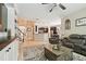 Spacious living room with tile flooring, a cozy seating area, and a seamless flow to the kitchen at 3530 Brook Crossing Dr, Brandon, FL 33511