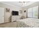 Cozy bedroom with a ceiling fan, a dresser, and a large window offering natural light at 3530 Brook Crossing Dr, Brandon, FL 33511