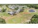 Stunning aerial view of the golf course, ponds, residential buildings, and community layout at 3839 Trophy Blvd # 3839, New Port Richey, FL 34655