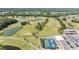 View of the community golf course with water hazards and a tennis court in the distance at 3839 Trophy Blvd # 3839, New Port Richey, FL 34655
