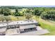 Scenic aerial view of the home with golf course and lush landscaping; including covered parking with four spaces at 3839 Trophy Blvd # 3839, New Port Richey, FL 34655