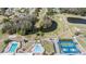 Aerial view showcasing the community's pool, tennis courts, and scenic pond at 3839 Trophy Blvd # 3839, New Port Richey, FL 34655