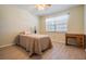 Bedroom with new floors, neutral paint, a ceiling fan and large windows with a view at 3839 Trophy Blvd # 3839, New Port Richey, FL 34655