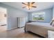 Comfortable bedroom featuring wood-look floors, a window with a view, and a ceiling fan at 3839 Trophy Blvd # 3839, New Port Richey, FL 34655