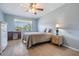 Cozy bedroom featuring a window with a view, wood-look floors, and a neutral color palette at 3839 Trophy Blvd # 3839, New Port Richey, FL 34655