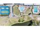 Aerial view showcasing amenities: tennis courts, pools, and green spaces in community at 3839 Trophy Blvd # 3839, New Port Richey, FL 34655
