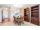 Inviting dining area featuring a table for four, wood-look flooring, and an open view to the kitchen at 3839 Trophy Blvd # 3839, New Port Richey, FL 34655