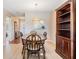 Cozy dining area with wood furniture, light wood flooring, and view to kitchen at 3839 Trophy Blvd # 3839, New Port Richey, FL 34655