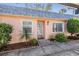 Front exterior of home showcasing the entryway, walkway, and lush landscaping at 3839 Trophy Blvd # 3839, New Port Richey, FL 34655