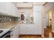 Charming kitchen with stainless steel sink, and open view to dining area featuring decorative tile backsplash at 3839 Trophy Blvd # 3839, New Port Richey, FL 34655