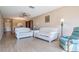 Comfortable living room with neutral paint, new flooring, a ceiling fan, and an open floorplan at 3839 Trophy Blvd # 3839, New Port Richey, FL 34655