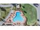 Aerial view of the geometrically designed pool featuring brick paving and ample seating at 3839 Trophy Blvd # 3839, New Port Richey, FL 34655