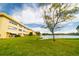 Scenic backyard with lake view, green lawn, and building in the background at 3850 13 N Ave # 113, St Petersburg, FL 33713