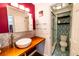 This bathroom boasts a vessel sink, a unique accent wall, and a stand-up shower at 3850 13 N Ave # 113, St Petersburg, FL 33713