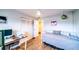 This bedroom has a ceiling fan, a twin bed, and hardwood floors at 3850 13 N Ave # 113, St Petersburg, FL 33713