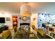 Open dining space with stylish light fixture and views to kitchen, and living areas at 3850 13 N Ave # 113, St Petersburg, FL 33713