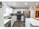 Clean kitchen with white cabinets, stainless steel appliances, and quartz countertop at 3850 13 N Ave # 113, St Petersburg, FL 33713